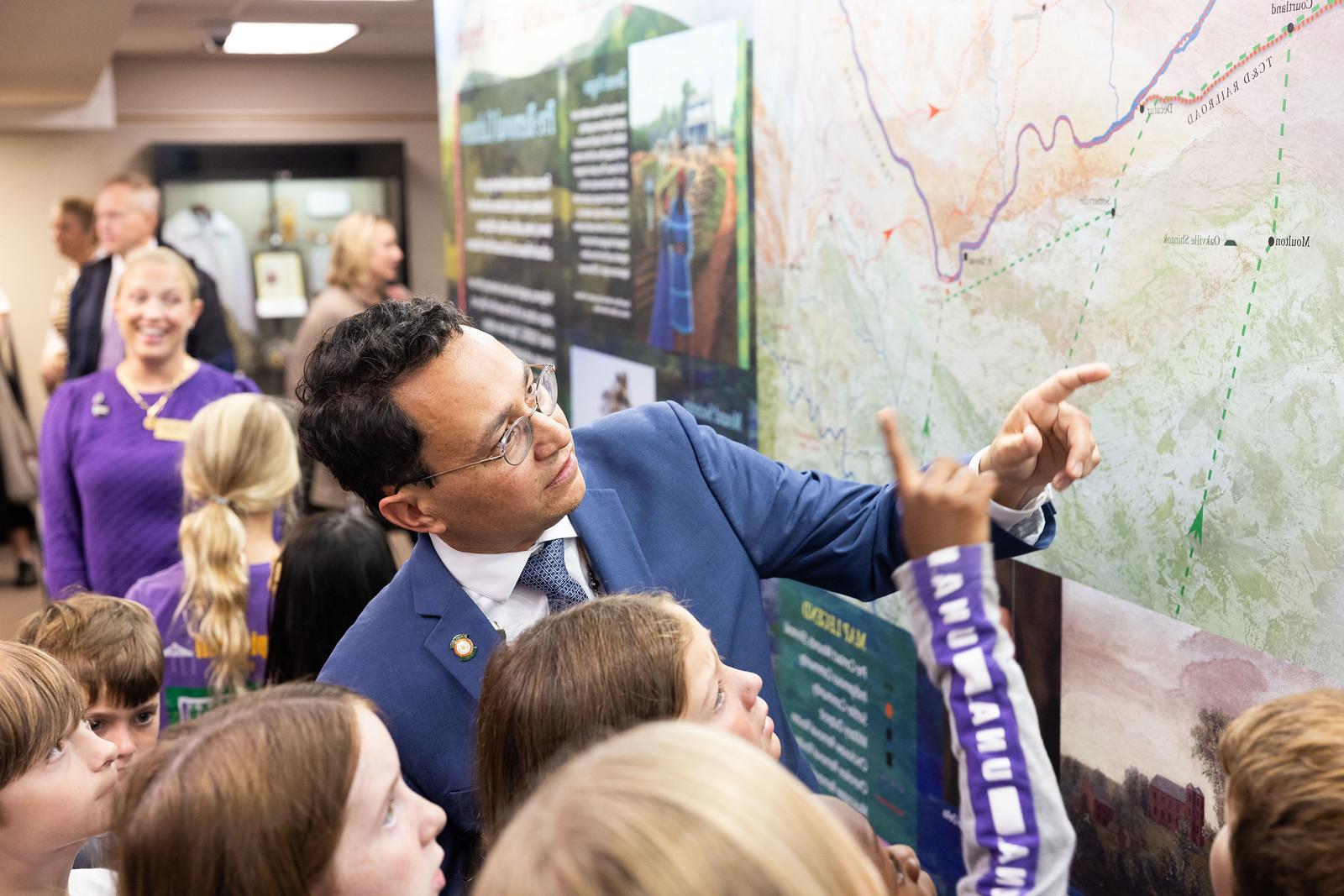 Cherokee Nation Principal Chief Chuck Hoskins Jr. interacts with the new mural honoring North Alabama's First People which was recently unveiled in Collier Library.